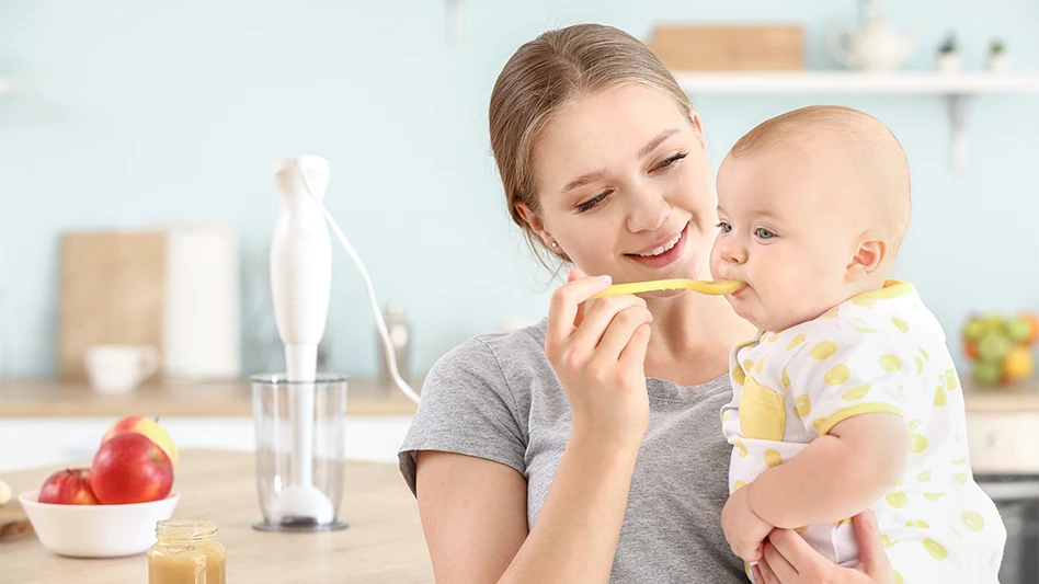 Baby being fed baby food